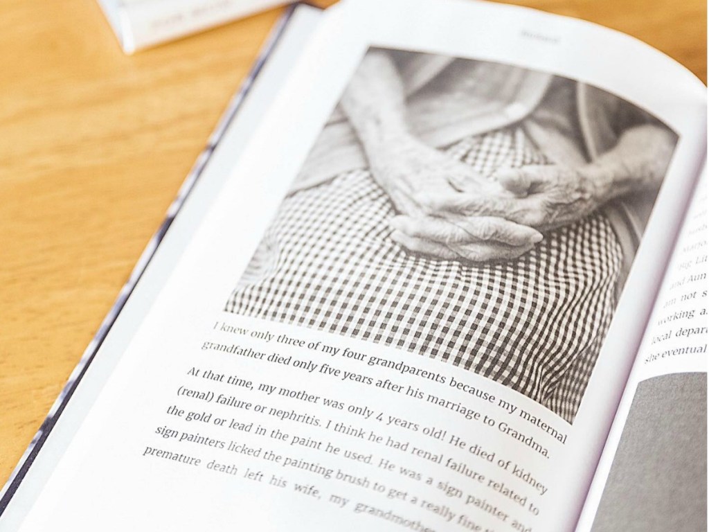 Book showing elderly woman's hand