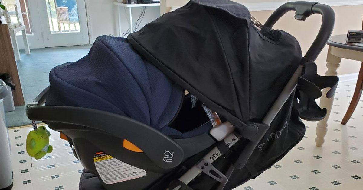 black summer travel stroller with carseat inside of it