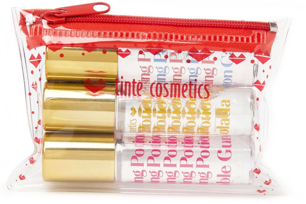 clear and red small cosmetics bag with three lip rollerballs inside