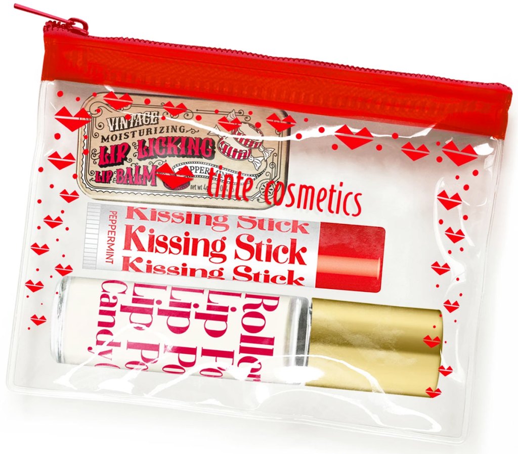 clear and red cosmetics bag with kissing stick, rollerball, and lip tin inside