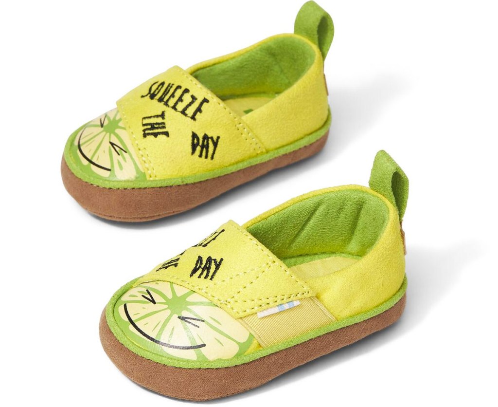 pair of yellow and green baby sneakers with lemons that say squeeze the day