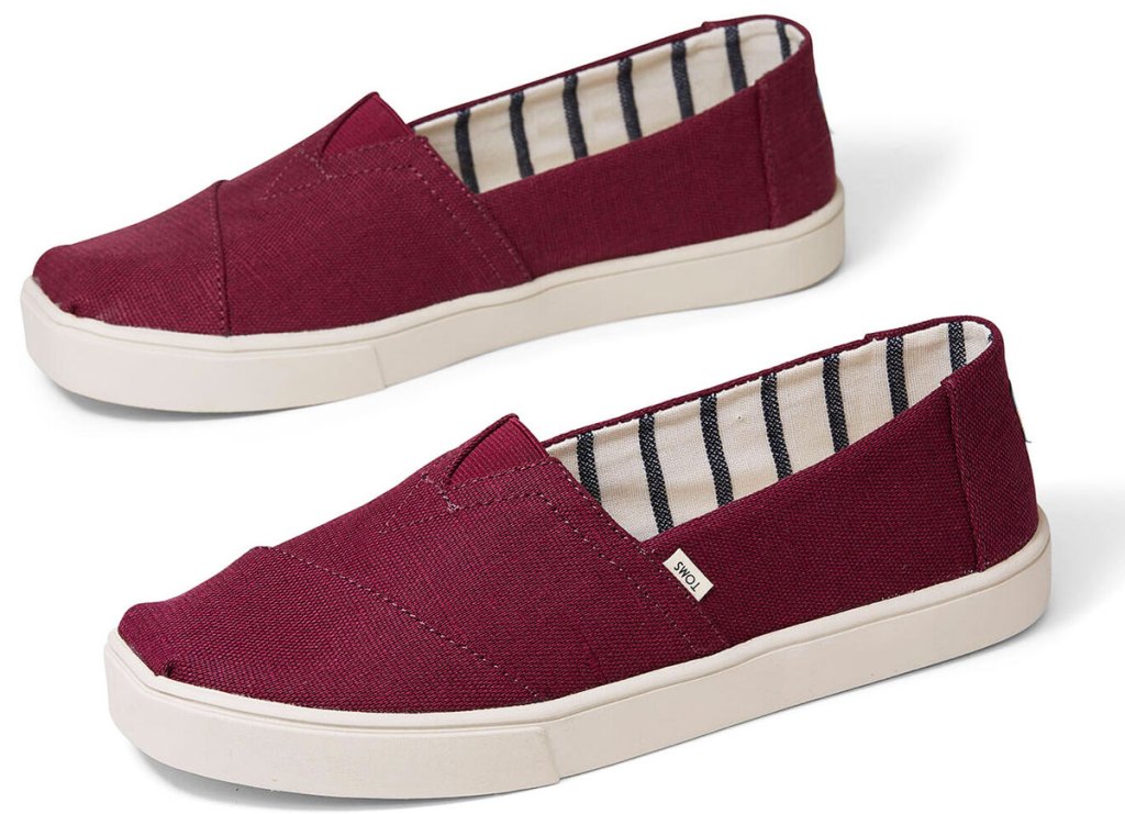 pair of burgundy colored canvas toms slip-on shoes