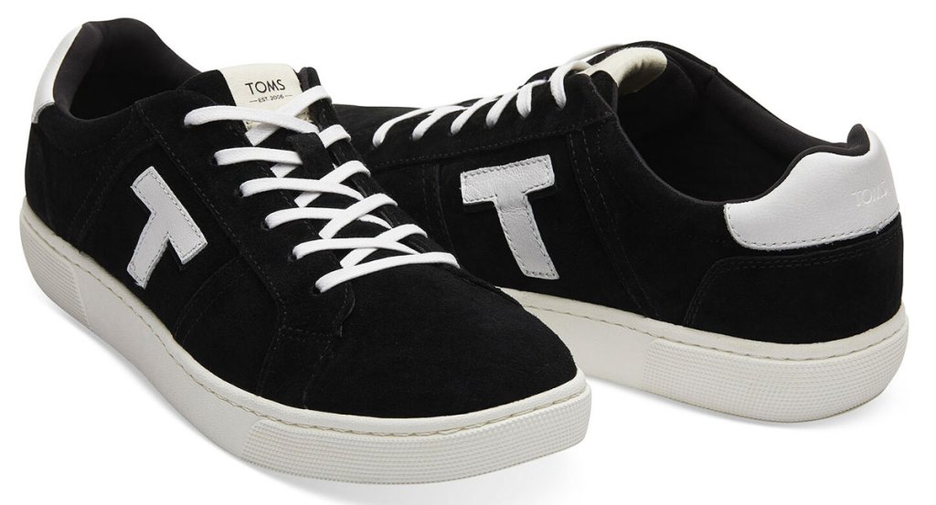 black sneakers with white T on the sides with white laces and rubber soles