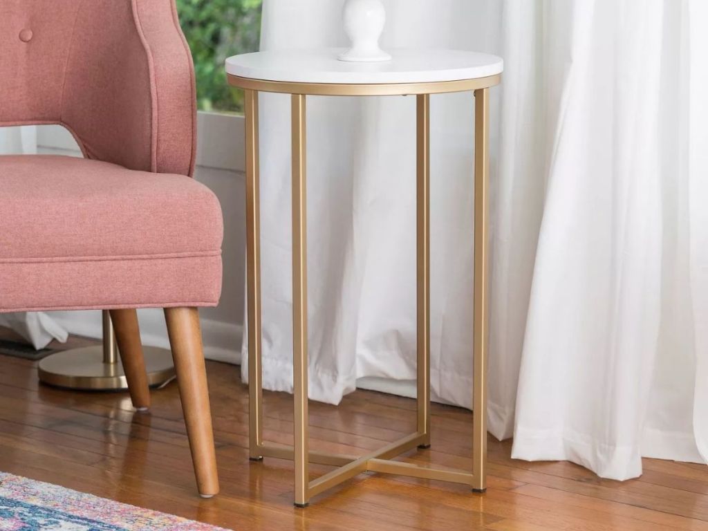 Target Brass Side Table next to pink chair