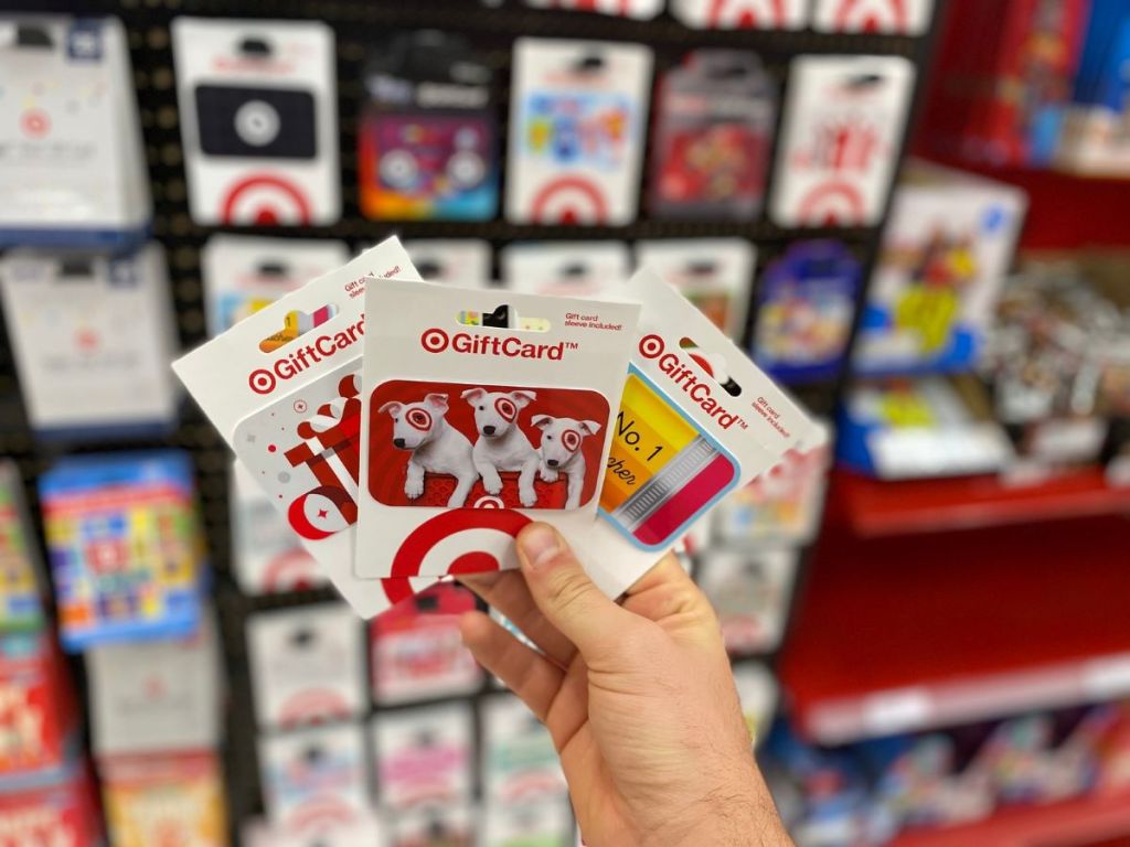 hand holding three Target gift cards