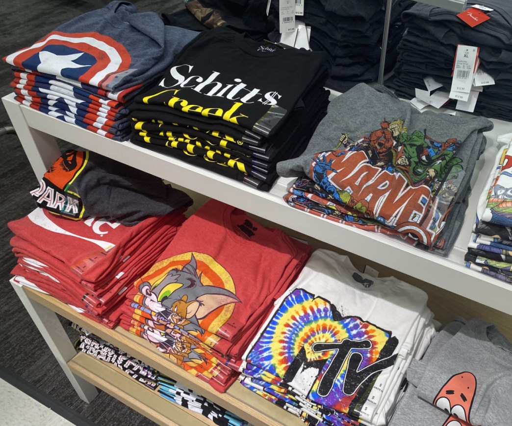 men's graphic tees folded on display table in store
