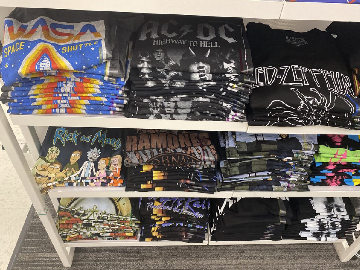 men's graphic tees folded on display table in store