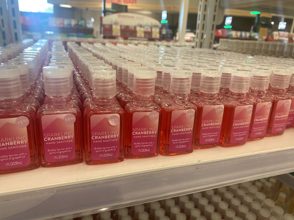 shelf with multiple pink colored pocket hand sanitizers in target
