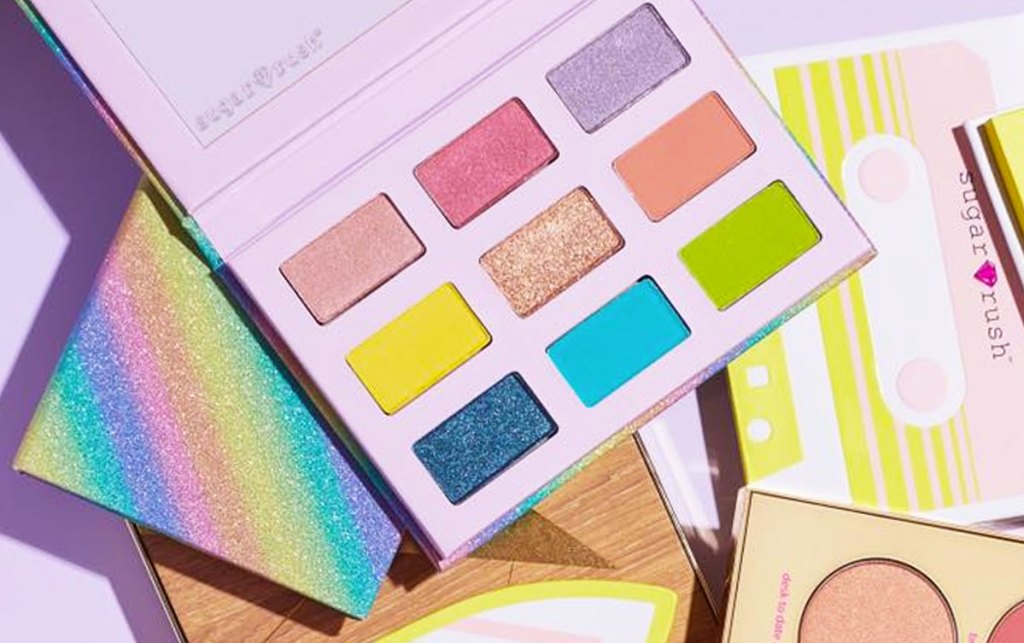 tarte eyeshadow palette with 9 rainbow shades on top of other eyeshadow palletes