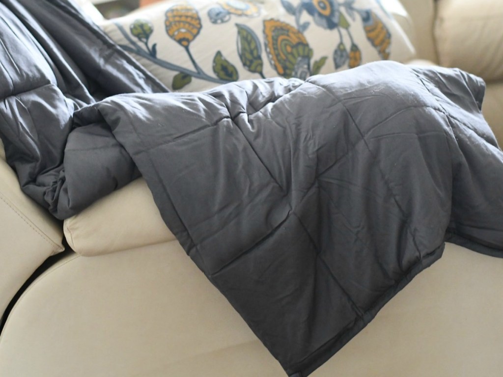 grey weighted blanket on a couch