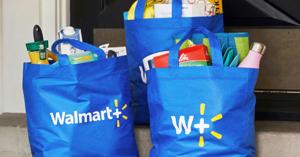blue walmart+ reusable shopping bags filled with groceries sitting on steps at front door