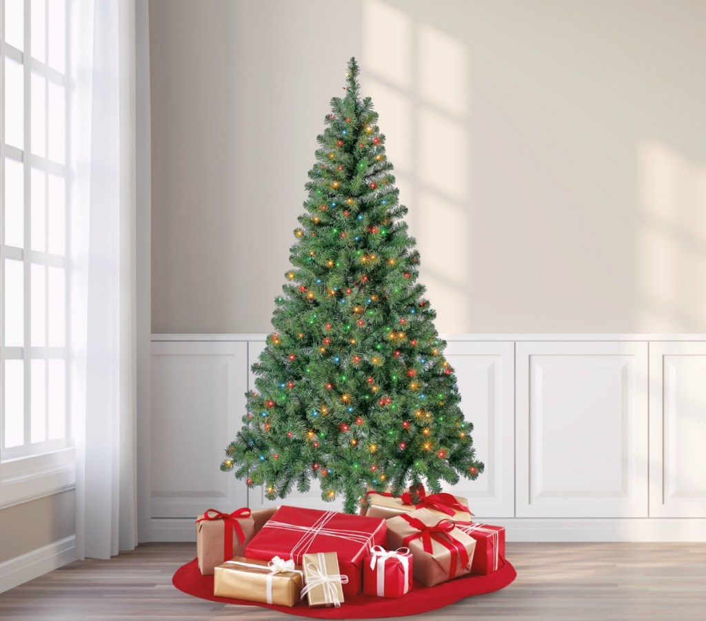 Large faux Christmas tree in a room with presents