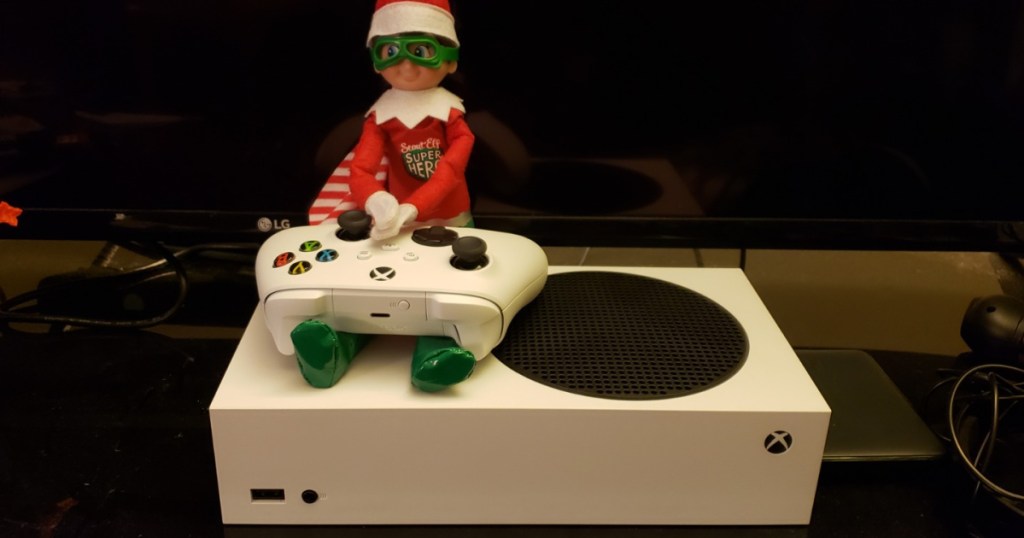 elf sitting on Xbox Series S console and controller