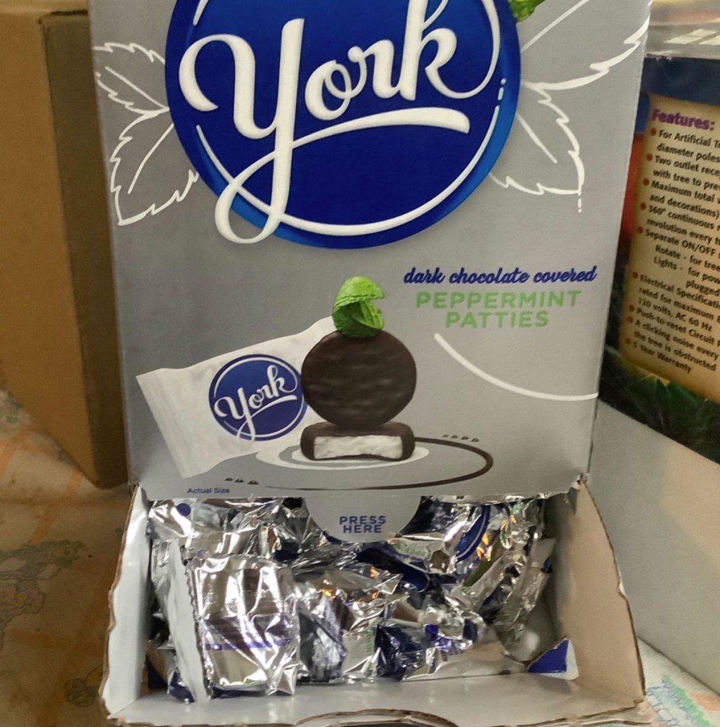 box of york peppermint patties with bottom opened showing individually wrapped candies inside