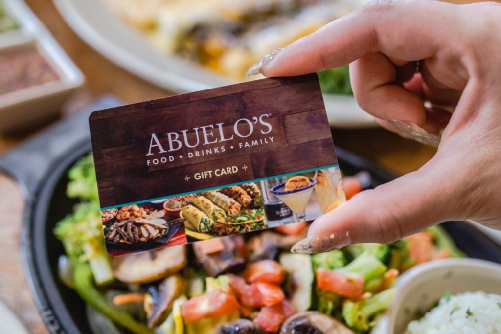 holding an Abuelo's gift card