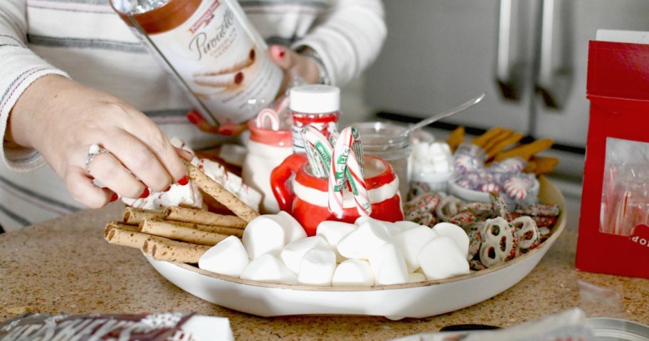 adding cookies to hot cocoa charcuterie