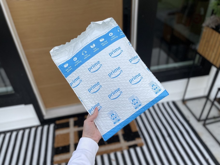 holding an Amazon bubble mailer