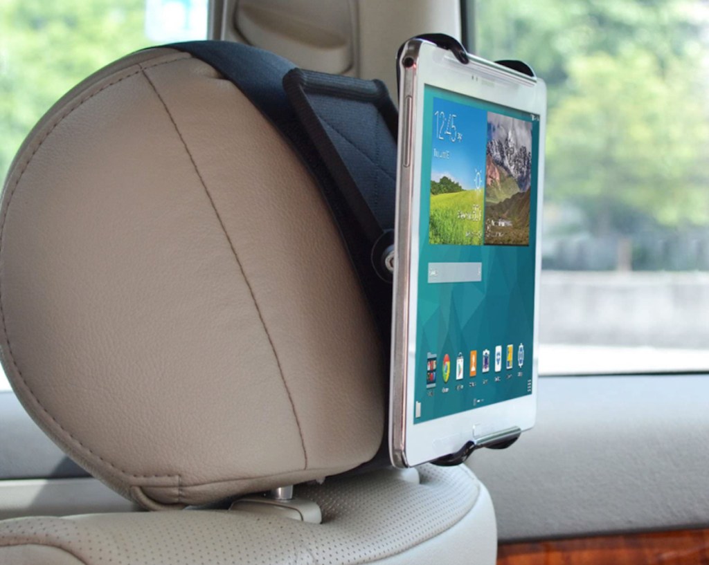 ipad clipped to headrest holder on back of car seat