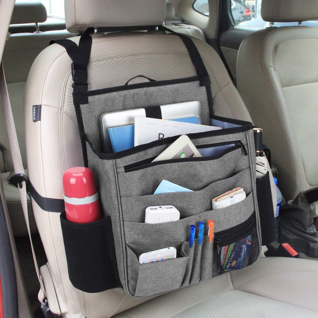 front seat of car with organizer stocked with water bottle pens and paperwork