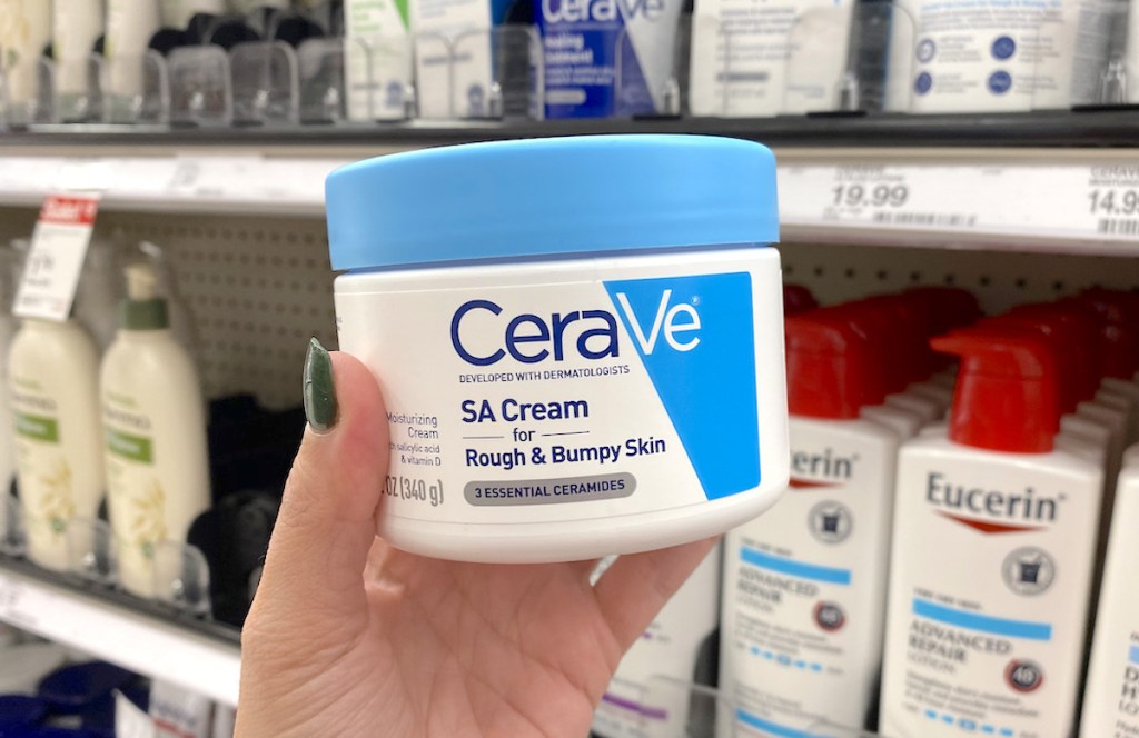 hand holding a tub of cerave cream in store aisle