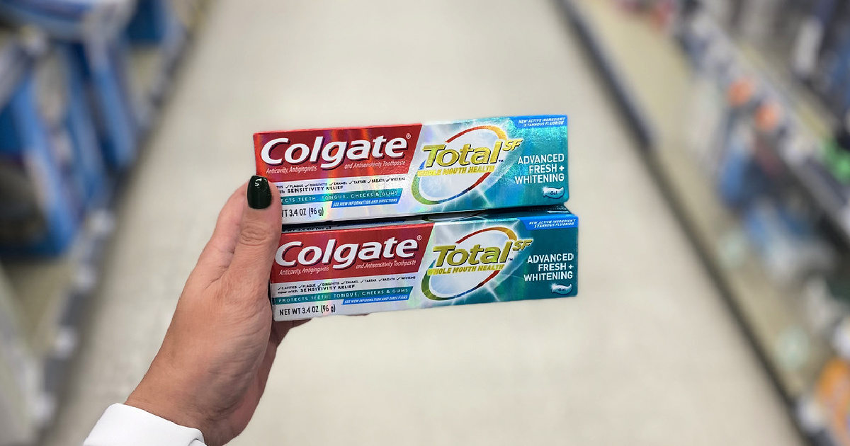 colgate total toothpaste in woman's hand at store