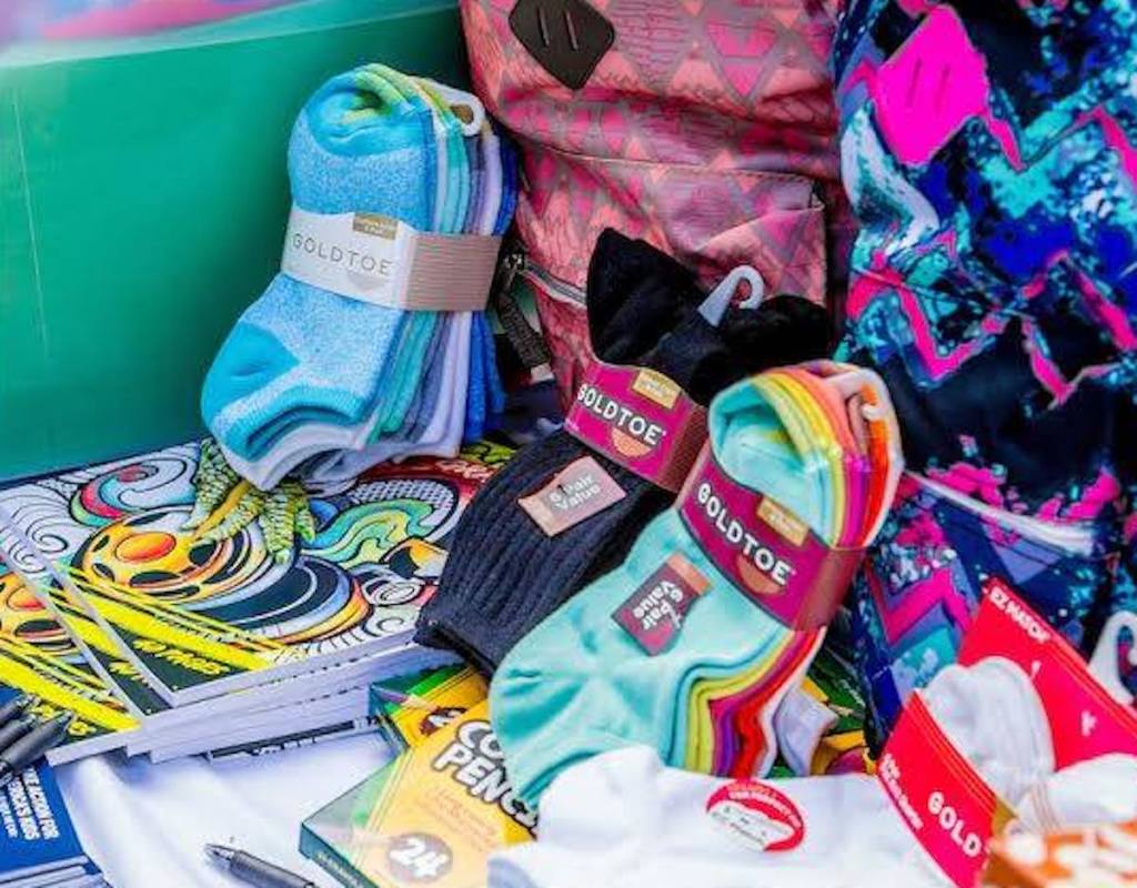 colored pairs of goldtoe socks with school supplies around it