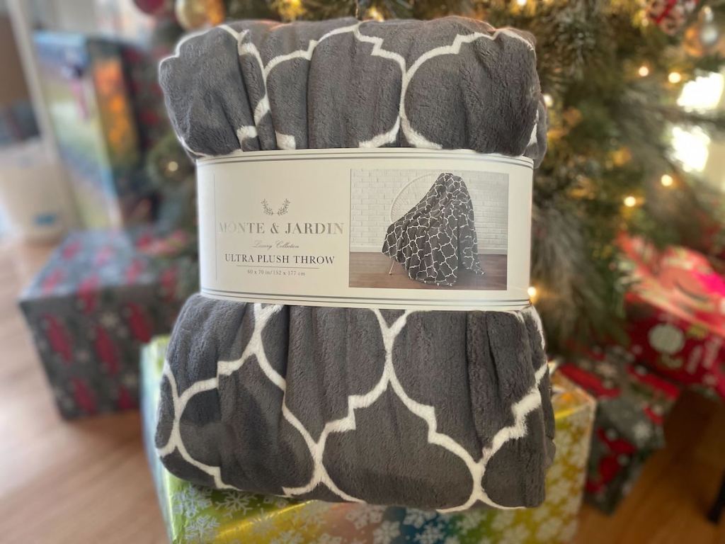 gray throw blanket in front of christmas tree
