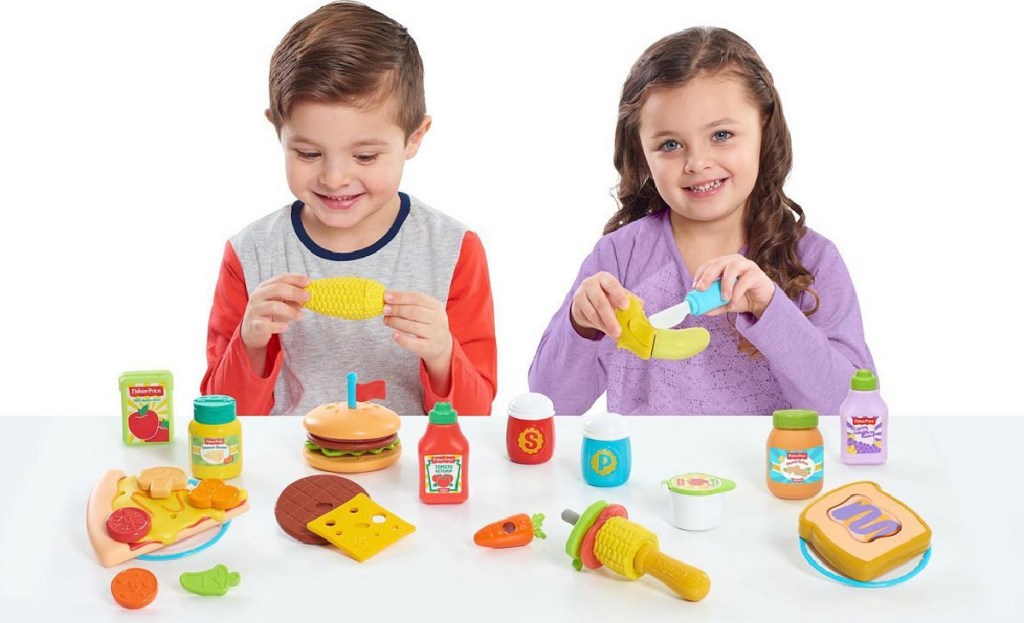 two kids playing with fisher price food set