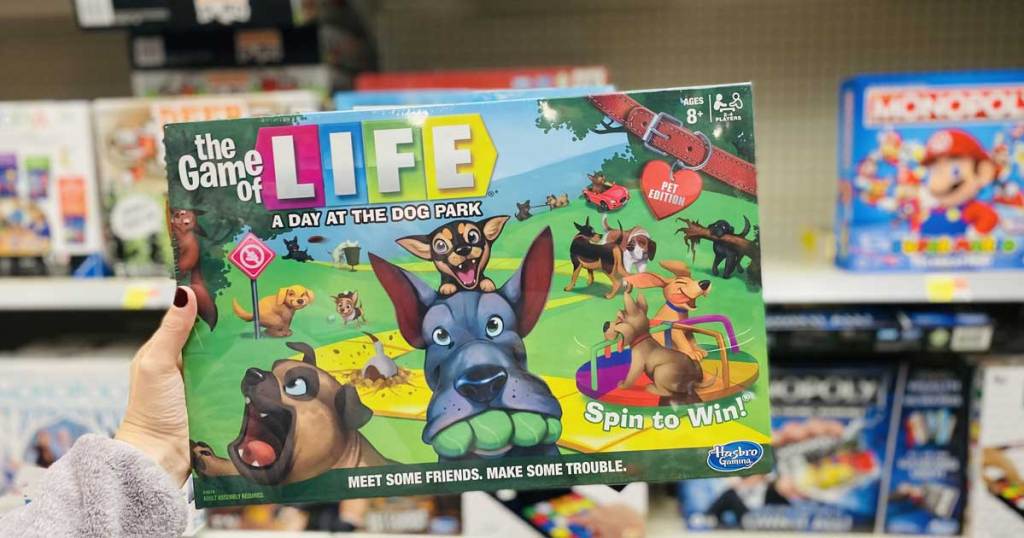hand holding a board game with dogs on it