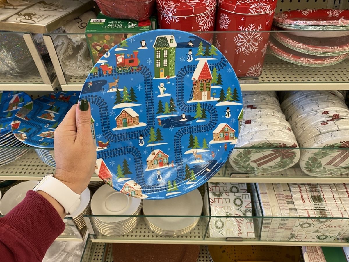 hand holding blue Christmas plate