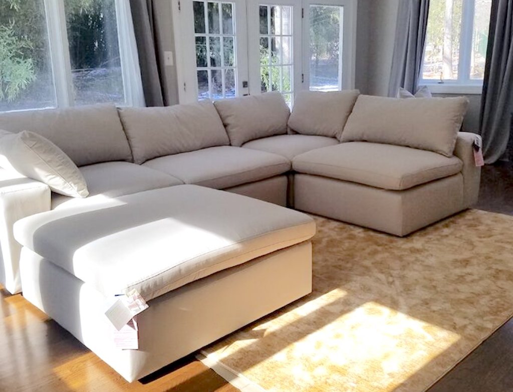 beige sectional sofa in room with windows and doors