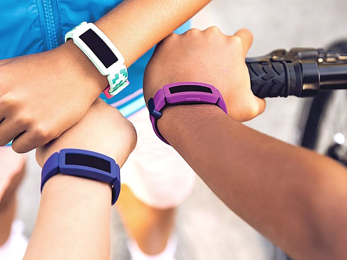 kids showing their fitbits on their wrists