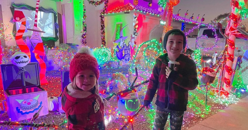 kids next to christmas light display