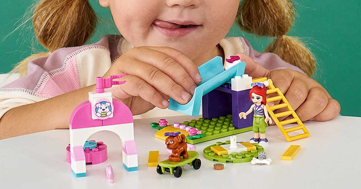 little girl playing with LEGO set