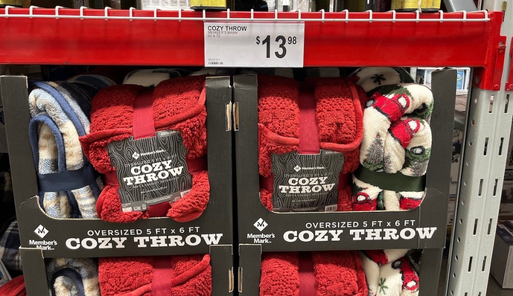 club aisle boxes filled with red cozy throw blankets - sams club gifts