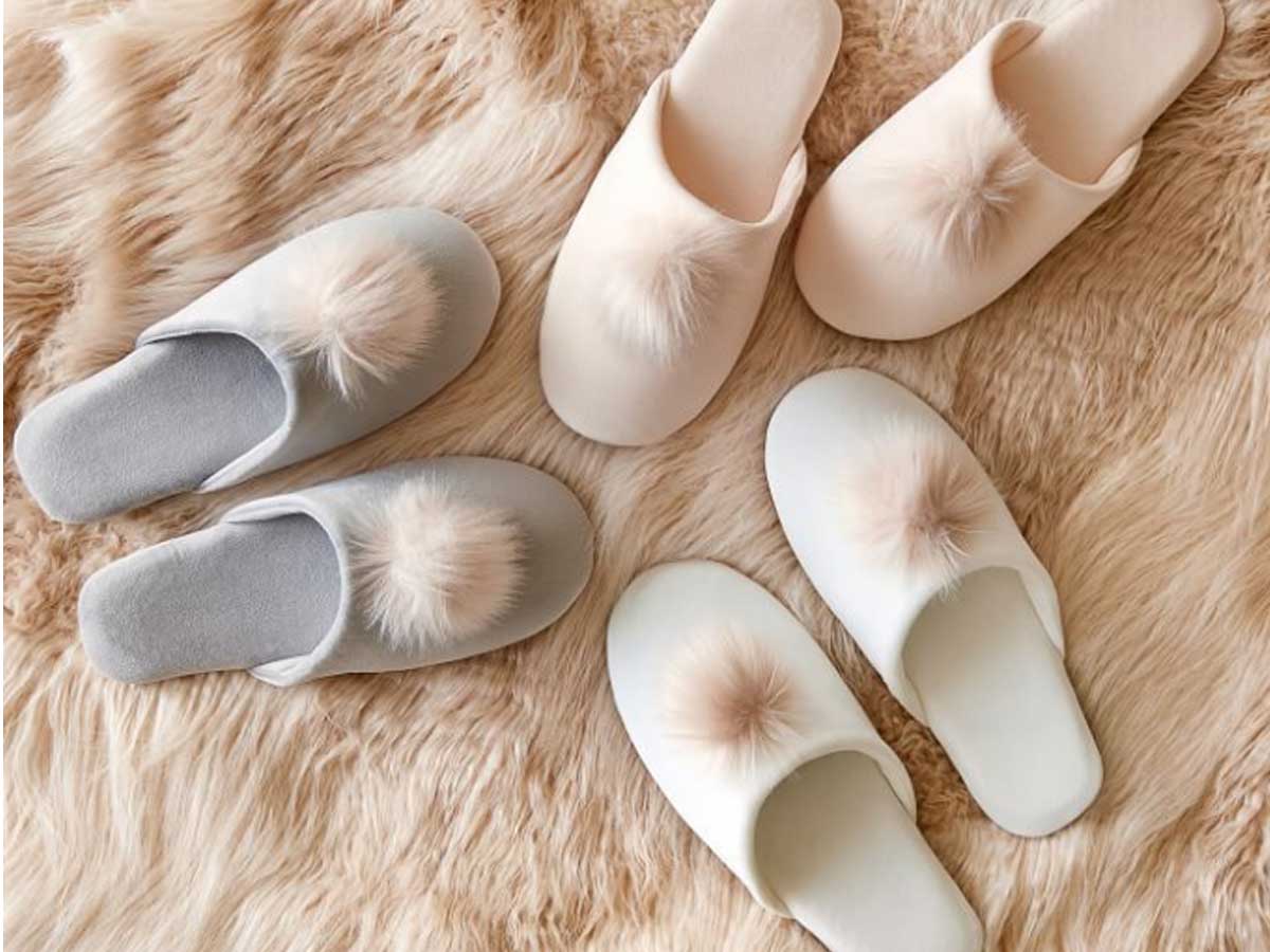 pom pom slippers on furry rug