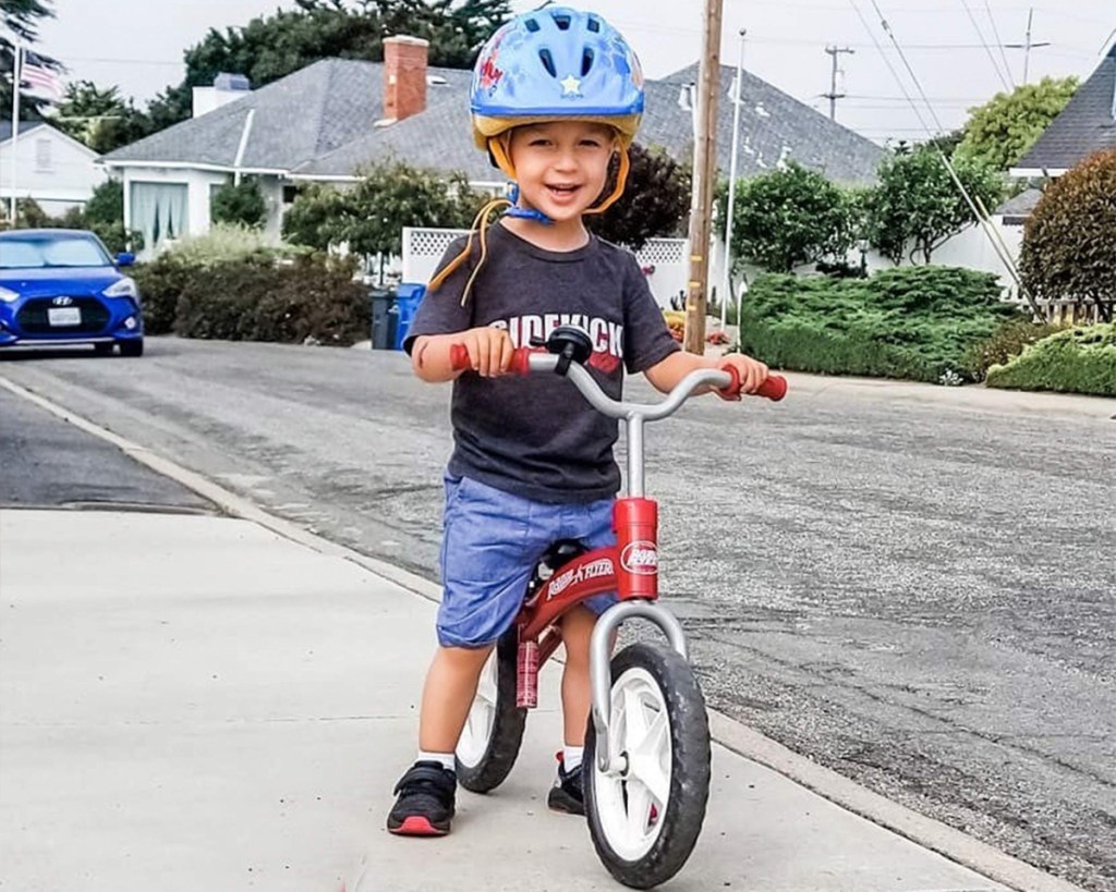 little boy riding radio flyer bike