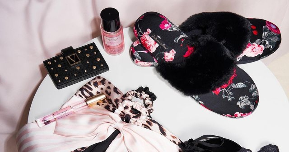 Victoria's Secret fur trim slipper on a table with other Victoria's secret accessory items