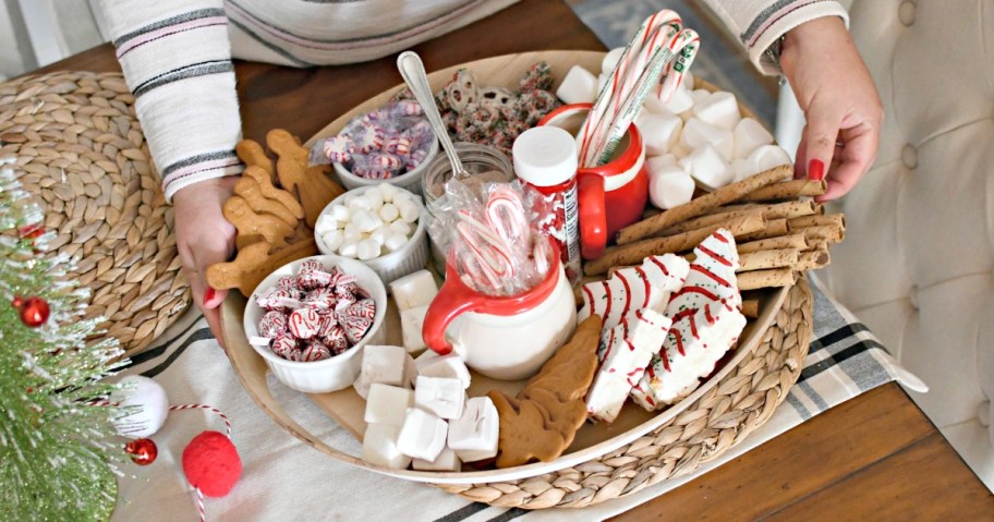 woman holding hot chocolate charcuterie tray