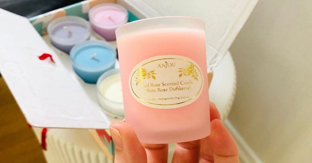 hand holding pink Anjou candle