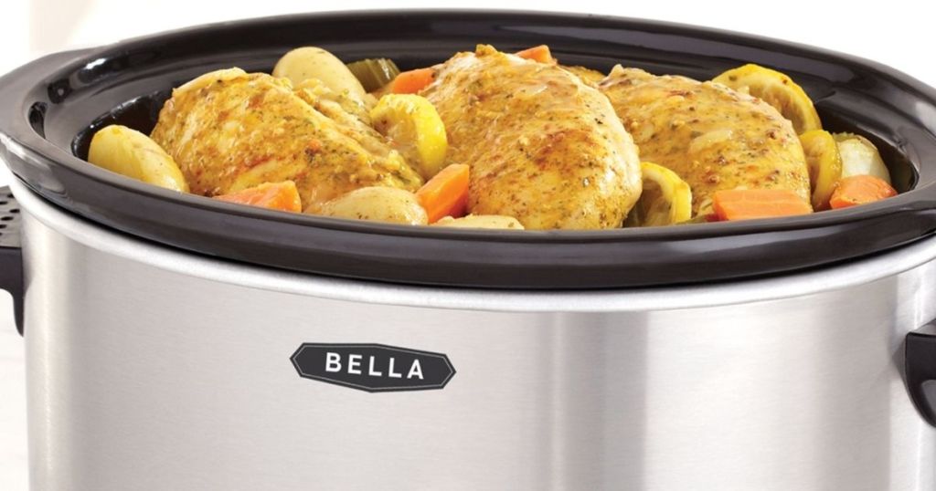 slow cooker with chicken and vegetables in it