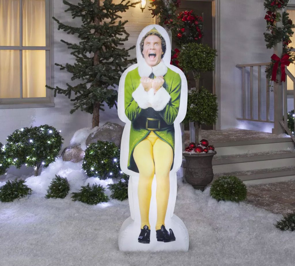 buddy the elf inflatable in a snowy front yard