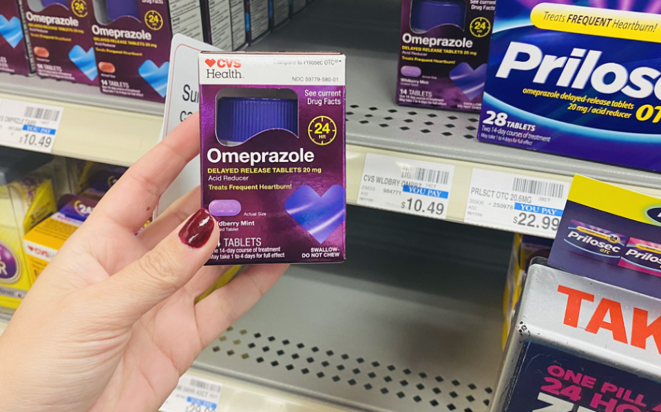 hand holding package of CVS Health Omeprazole 20mg
