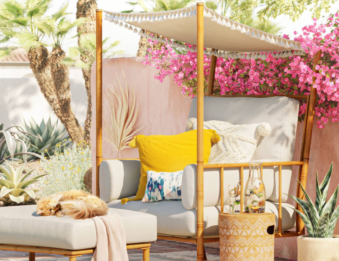 white canopy chair with ottoman in backyard