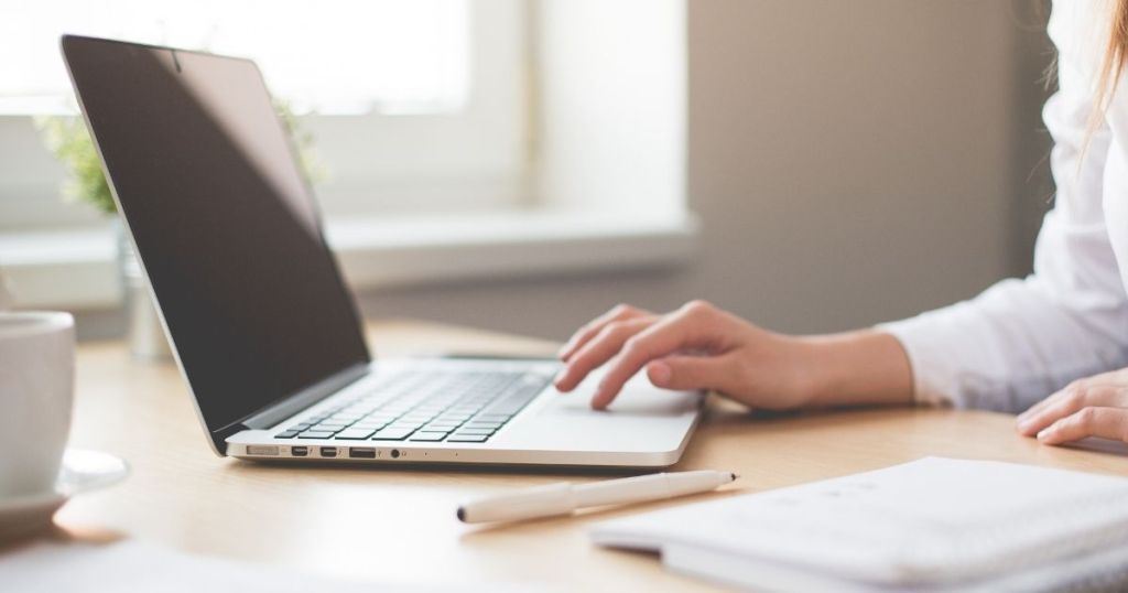 woman working on a computer thanks to the Affordable Connectivity Program