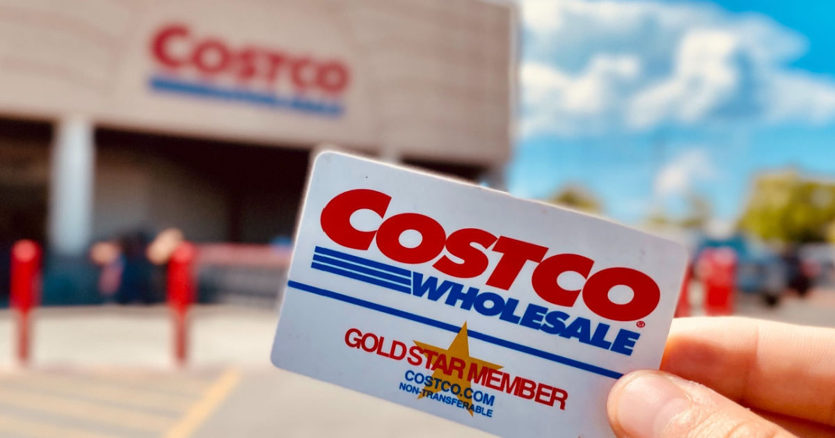 holding Costco card outside warehouse for travel deals
