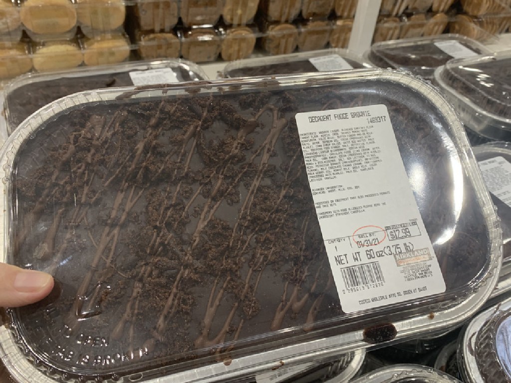 hand holding large fudge brownie container in store