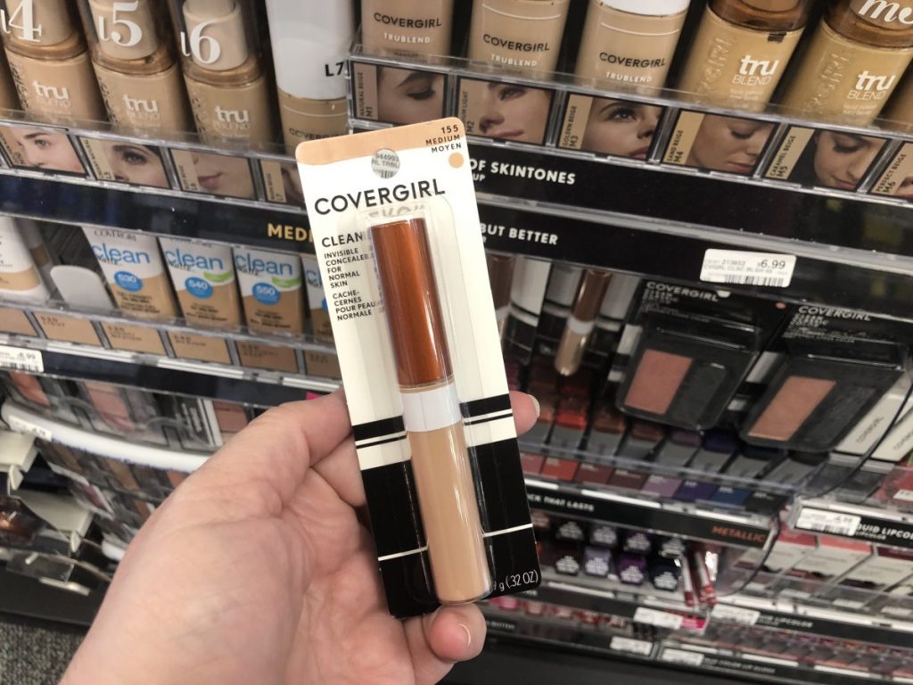 hand holding package of covergirl invisible concealer