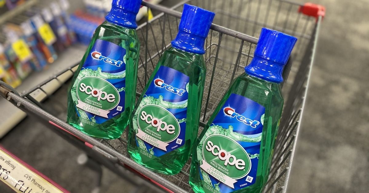 three bottles of crest scope mouthwash in a shopping cart