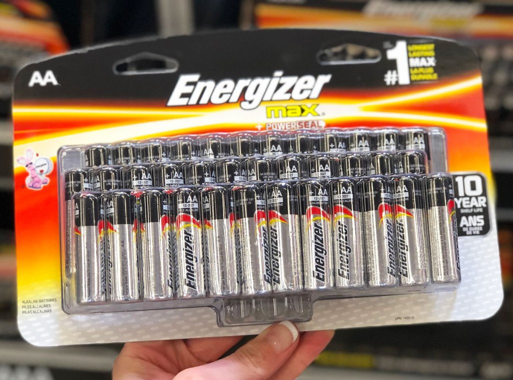 woman holding up large pack of energizer batteries
